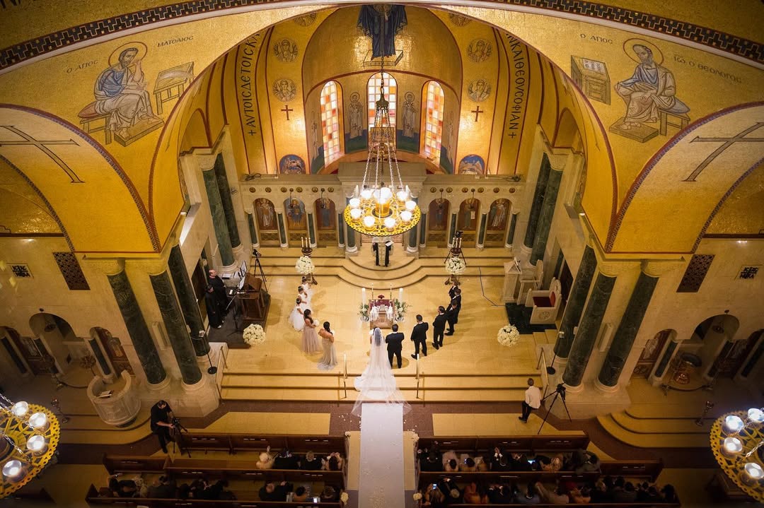 Wedding ceremony photographed from above inside an ornate church