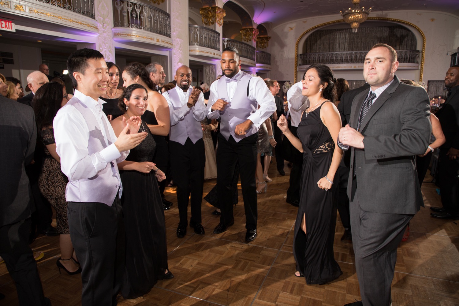 Guests dancing together at the wedding reception